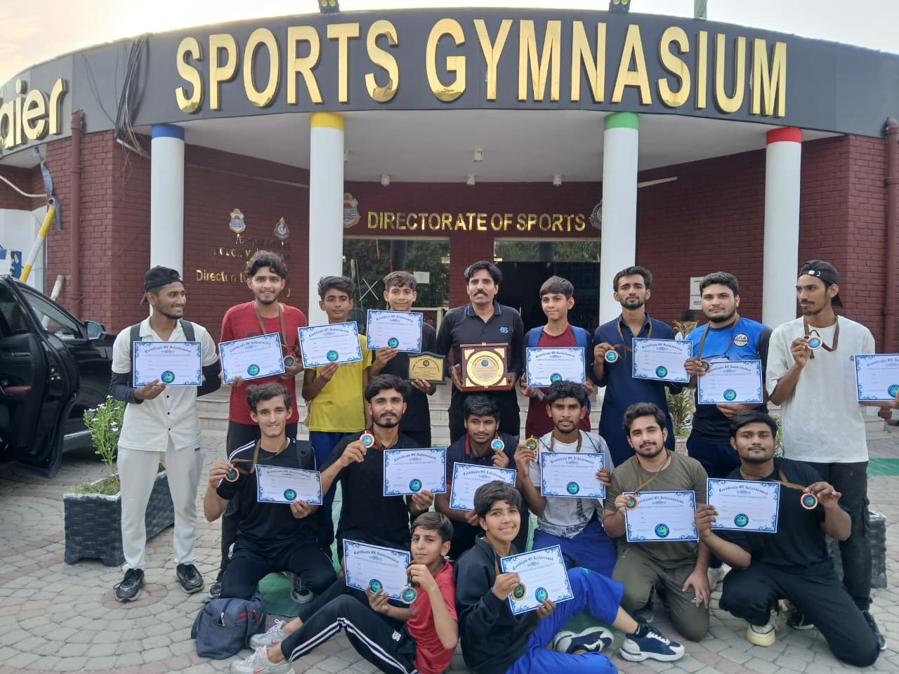 Victorious athletes in gis displaying award medals